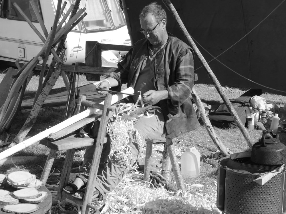 he didn't seem bothered about making a sale or anyone around him. He just kept peeling away and before I knew it he had made a scythe stem we call a snath or a sned. This is a conchoidal shaping in the straight first and then steamed and bent to shape to fit around the body to allow pressure points to be applied during scything swings.